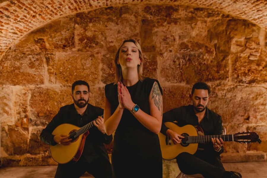 Lisbon: Fado Show with Wine in a Historic Venue - Fado beneath old stone near Lisbon Sé