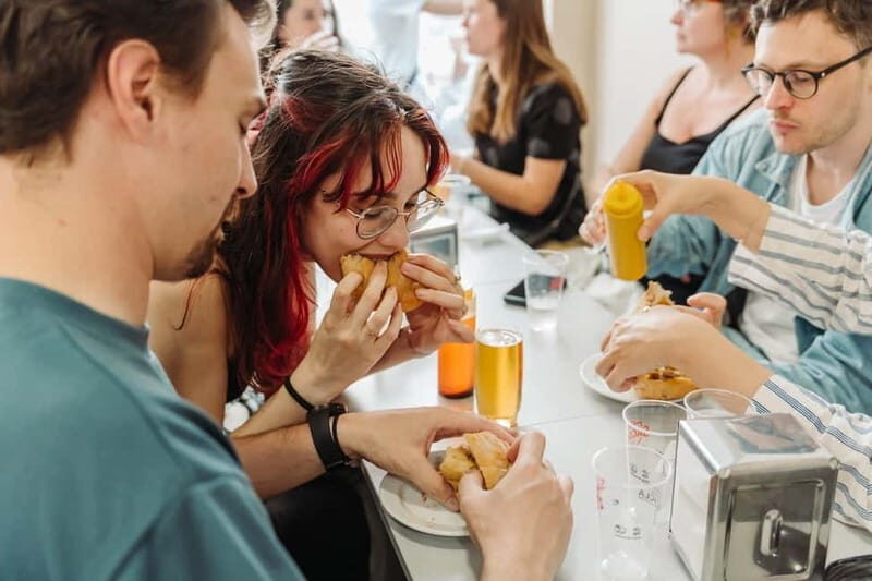 Lisbon: Tastes and Traditions Guided Food Tour - Ham, grocery finds, and savory bites at O Trevo and O Gaiteiro